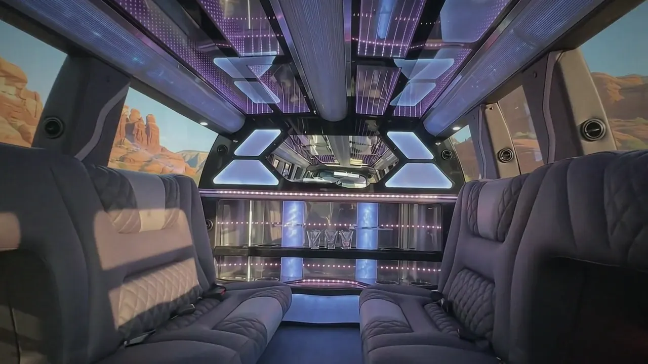 Inside the Cadillac Escalade limo in Longmont: LED light-show ceiling, leather lounge seating and lit bar